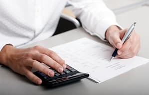A businessman calculating expenses at tax time